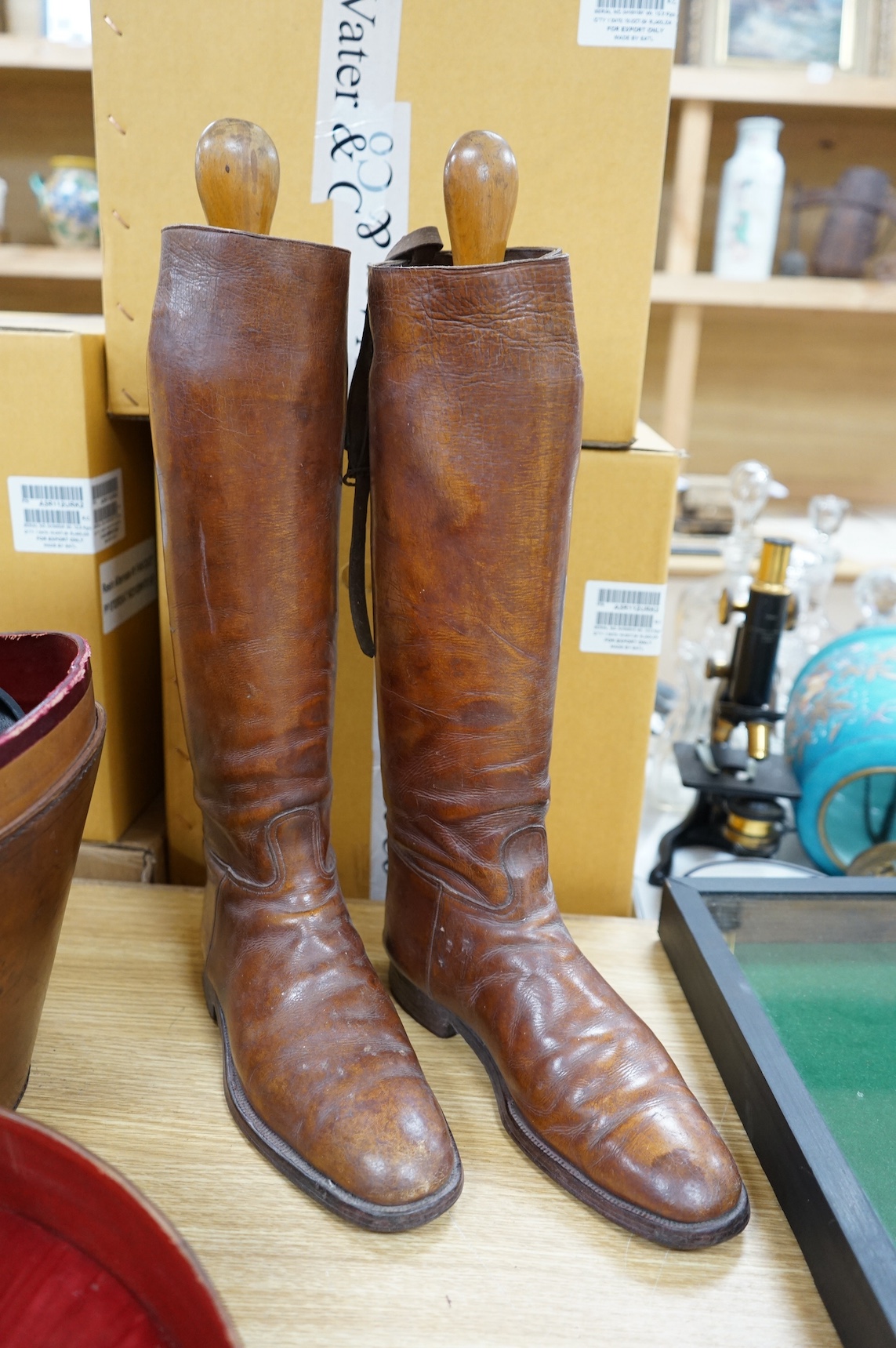 A pair of vintage leather riding boots and a leather cased top hat, ‘A.J. White, hatter to the Royal Family’. Condition - fair